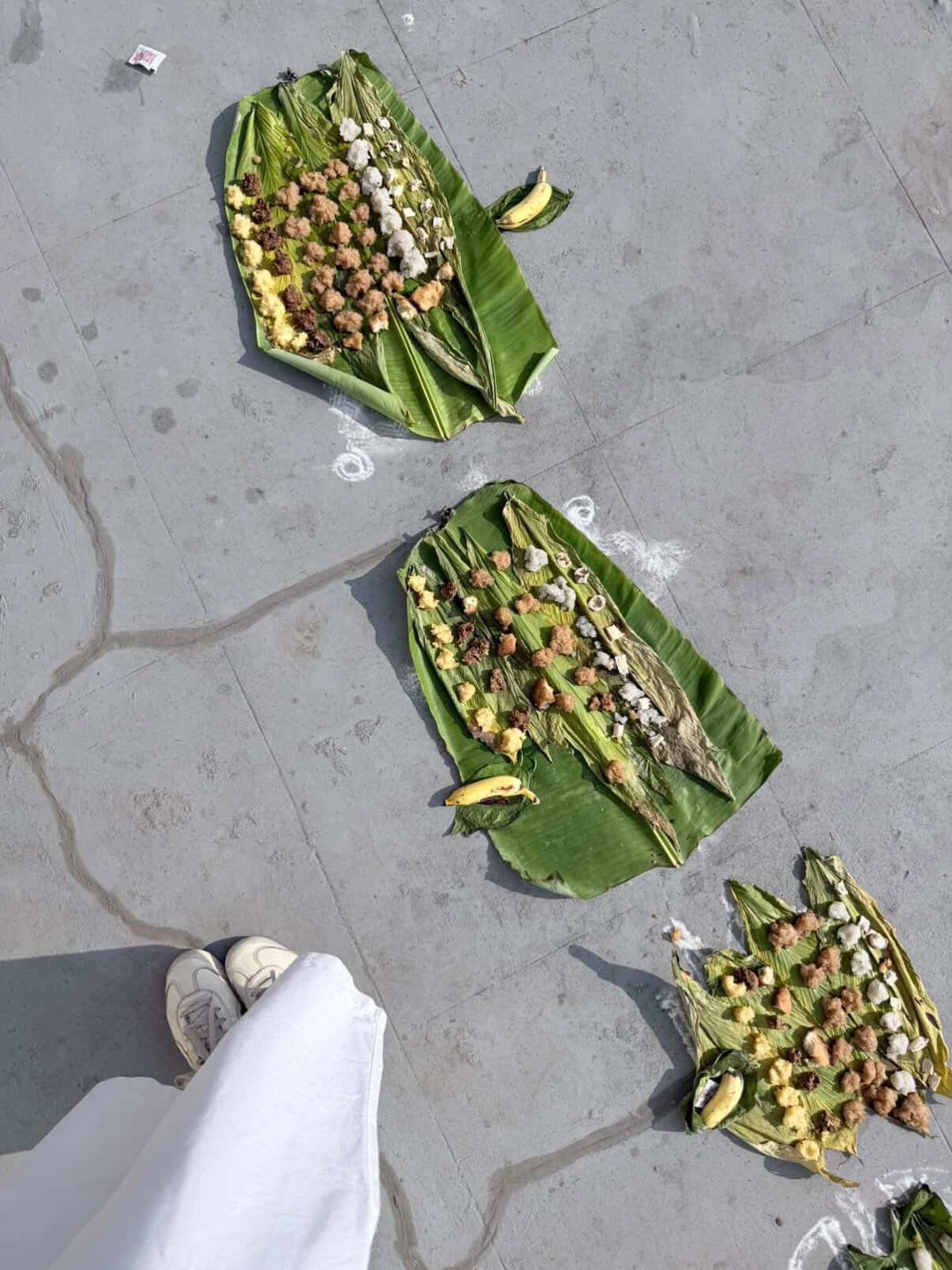Food laid out on banana leaves, seen from above