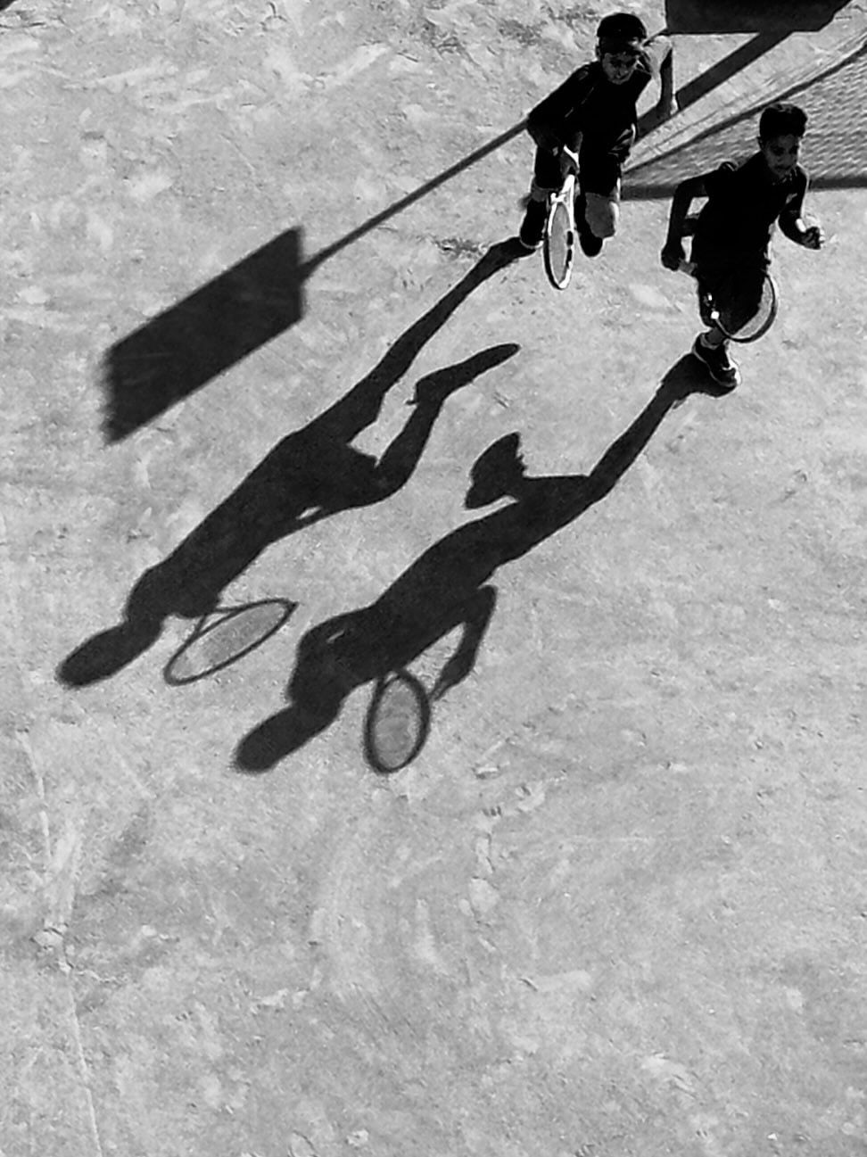 A black-and-white photograph of long shadows on a Bangalore street