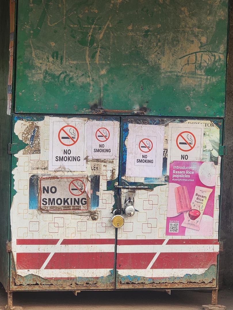 A weathered shopfront with No Smoking signs